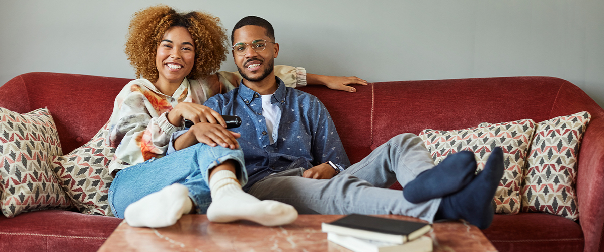 Man and woman sitting on a couch.