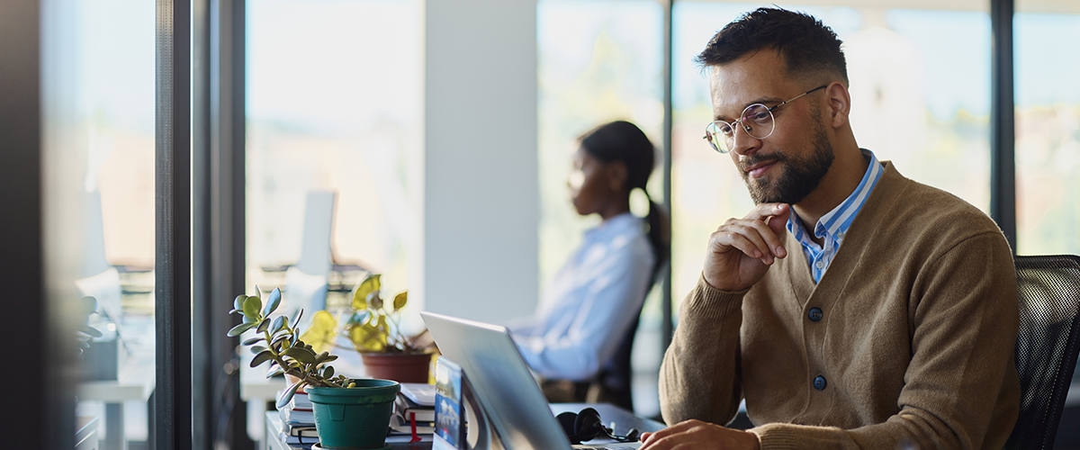 Man sitting at a desk working in an office building.