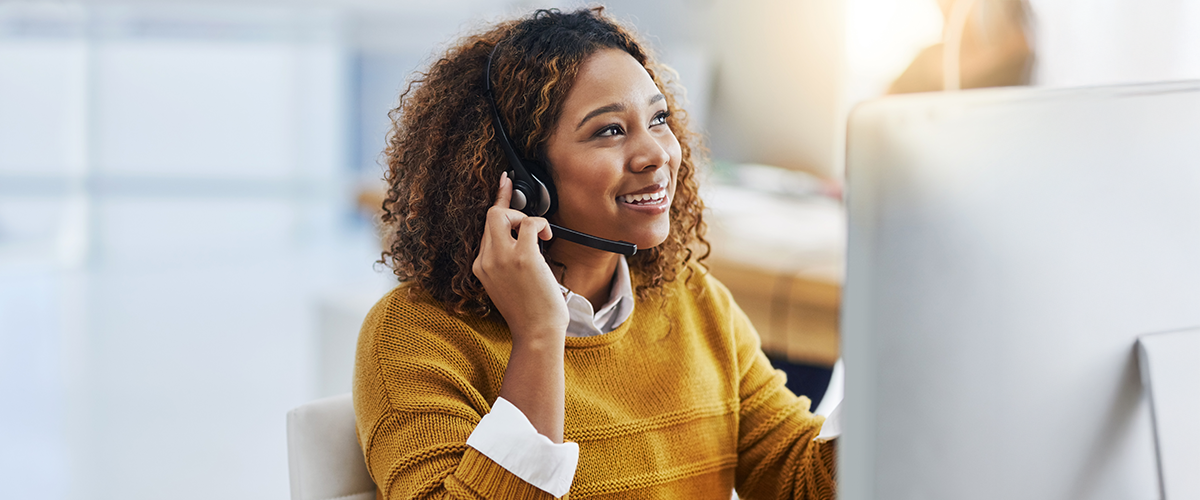 Customer service representative speaking into a headset.